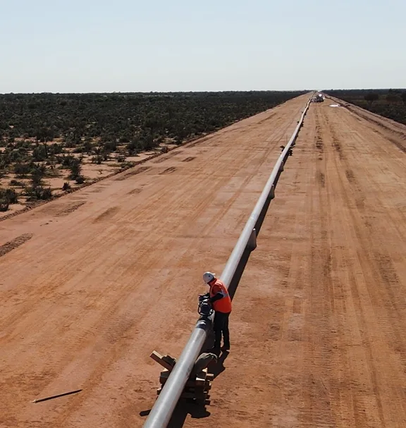 AXS technician inspecting a pipeline on a remote right-of-way